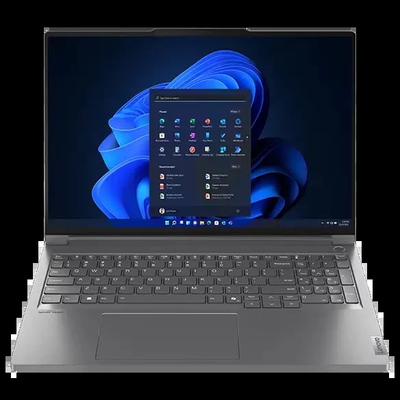 Silver laptop displaying Windows 11 start menu with blue flower design on screen, keyboard and trackpad visible